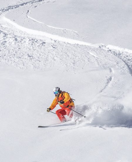 one man skiing, white snowy background, deep powder snow