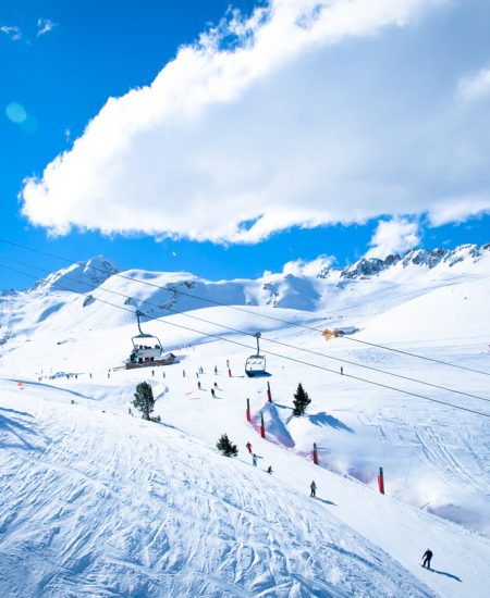 Chair lifts and skiers in a snowy winter landscape