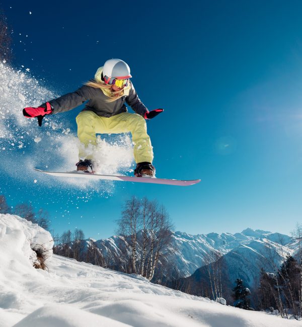 Girl is jumping with snowboard from the hill